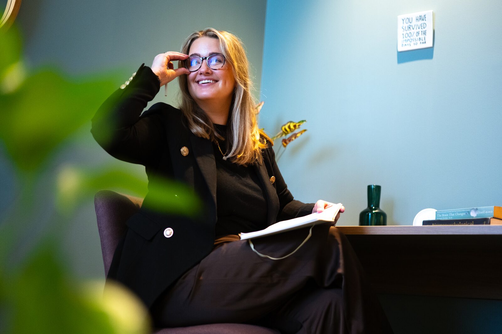 Maddy Smith, founder of Maddy Smith Mentoring, laughing with a notebook in her lap